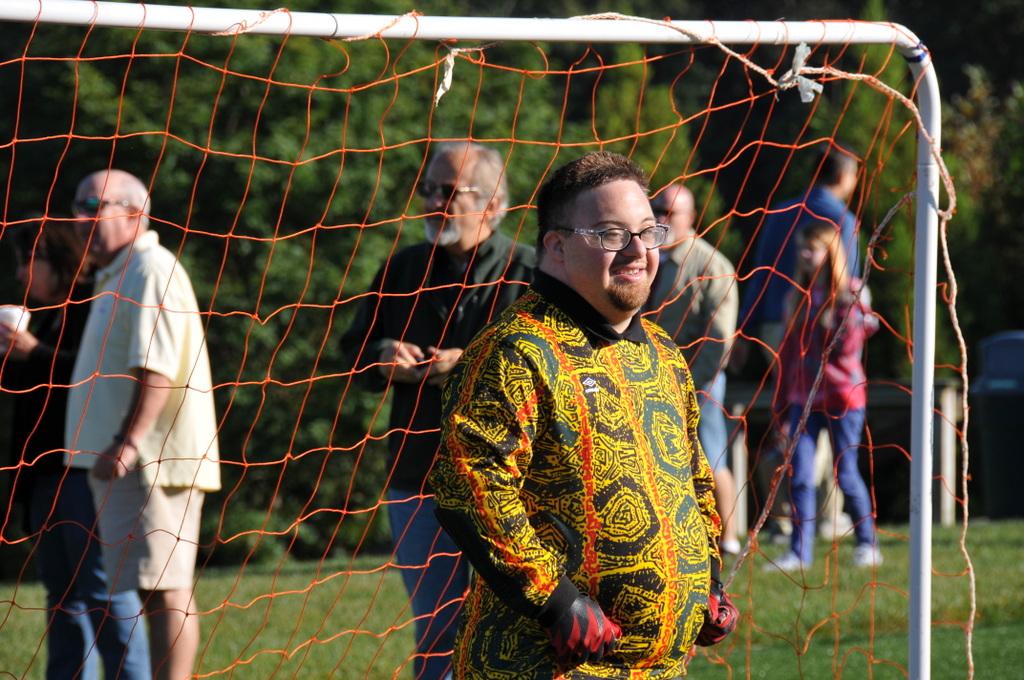 A goalie watches as the other team has the ball.