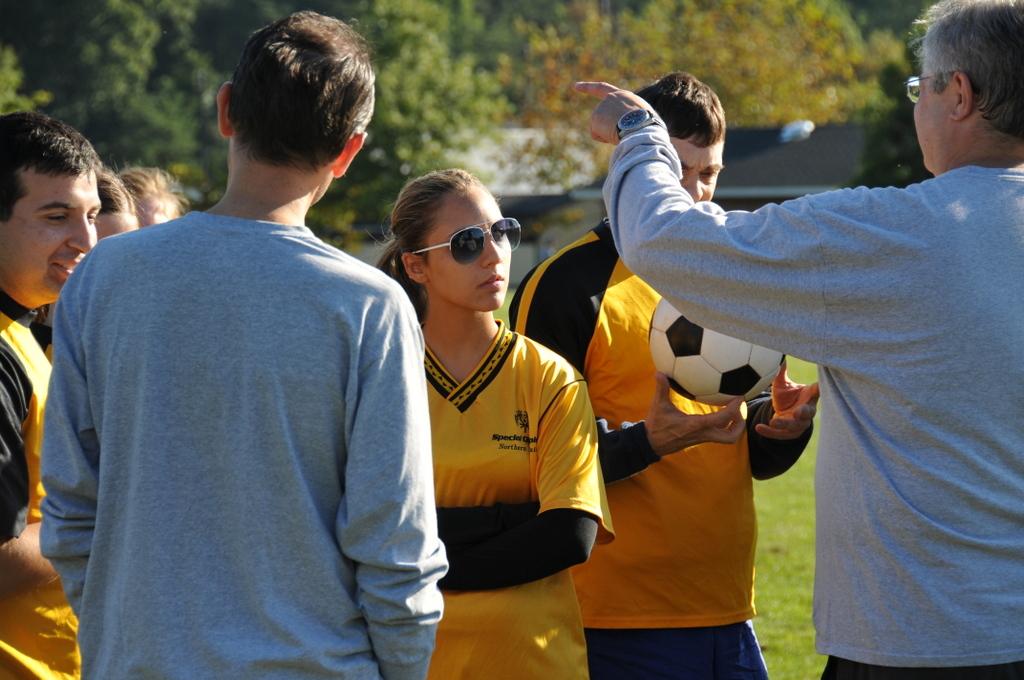 Players listen to their coach's game plan before they begin.