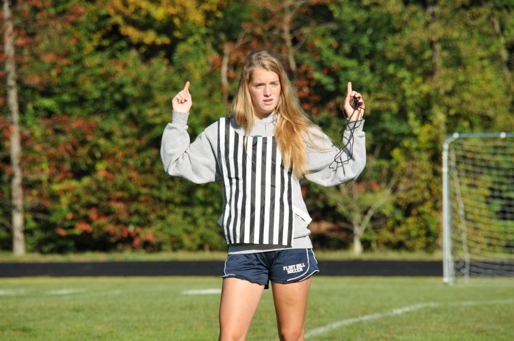 Referee and junior Madison Crowe signals the start of the game.