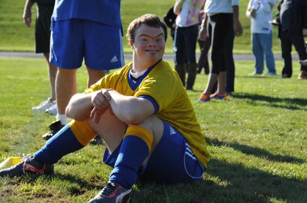 A player sits on the sidelines waiting to be substituted in.