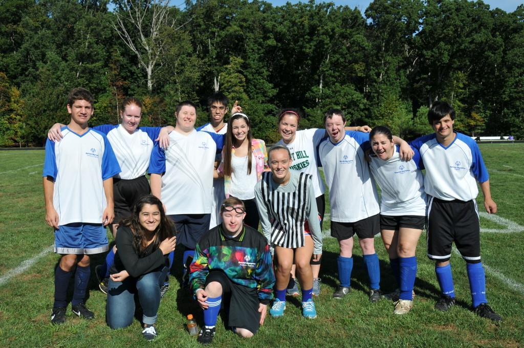 A team poses for a picture with volunteers.