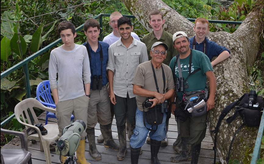 Students pose for a photo with their tour guides above the Amazon canopy. 