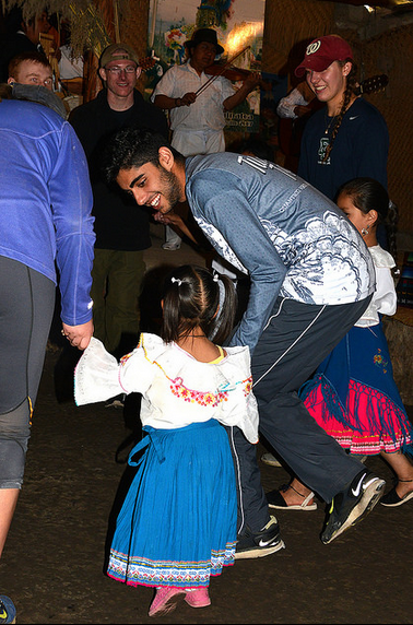 Students dance with Ecuadorian children. 