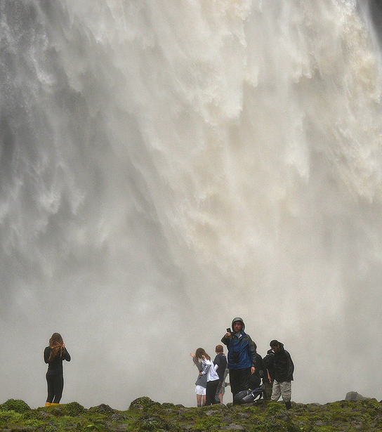 Students gaze at a waterfall as Senior Jack Morisette takes a selfie in the background. 
