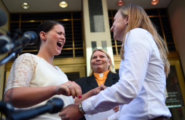 Jennifer Melsop, left, screams for happiness after being married to her partner, Erika Turner, in front of Arlington County Courthouse. Photo Credit: Astrid Riecken/For The Washington Post.