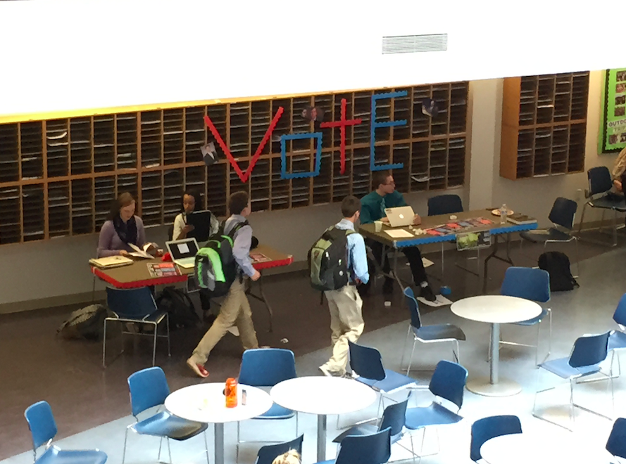 Students pass by the voting booth in the commons on November 4, 2014, in a mock election. 