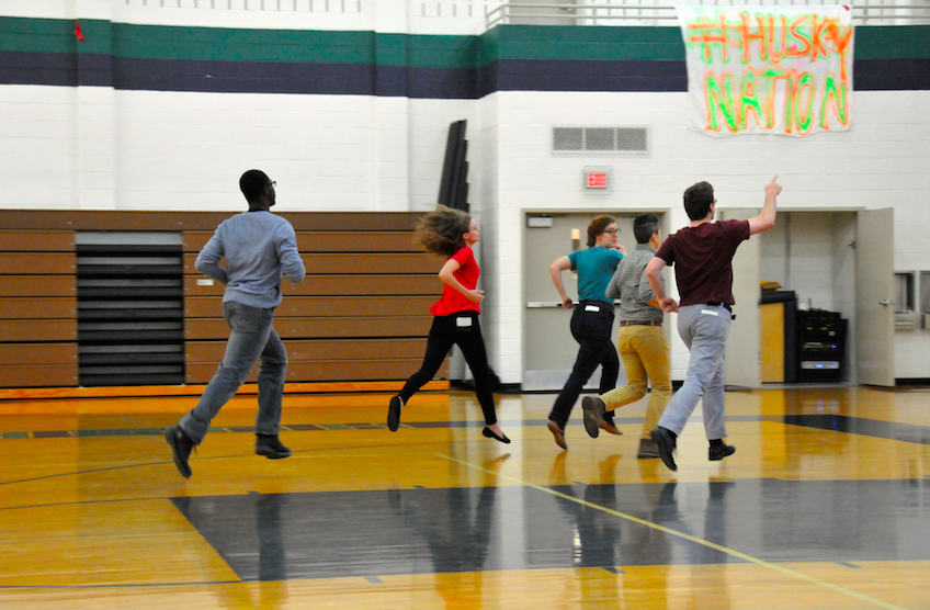 The actors from Speak About It run offstage following their presentation.