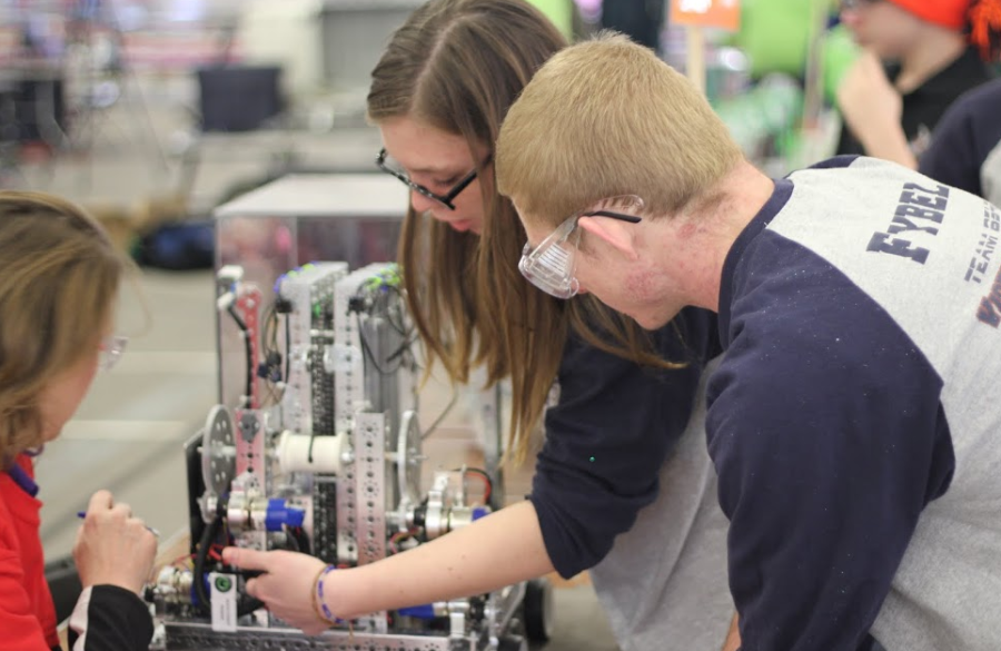 Juniors Benjamin Fybel and Cailin Mazan work on their robot at the RIchmond state robotics championship. 