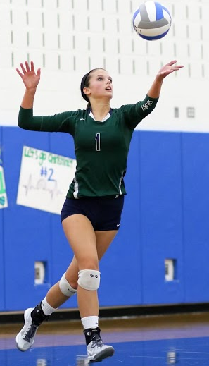 Freshman Kristian "Krissy" O'Malley serves the ball.