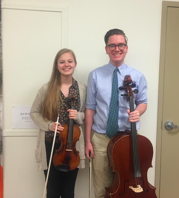 Junior Sydney Ebersohl and sophomore Patrick Lovelace pose with their respective instruments.