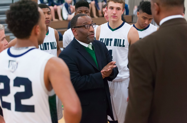 Before+they+take+the+court%2C+varsity+boys+basketball+coach+Rico+Reed+speaks+with+his+team%27s+players.