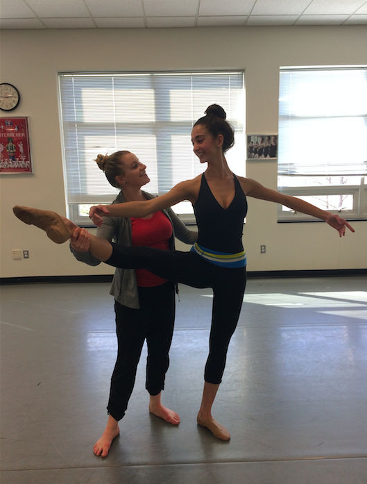 Dance teacher Olivia Landrum helps sophomore Lindsey Alloy with the finer points of her stance.