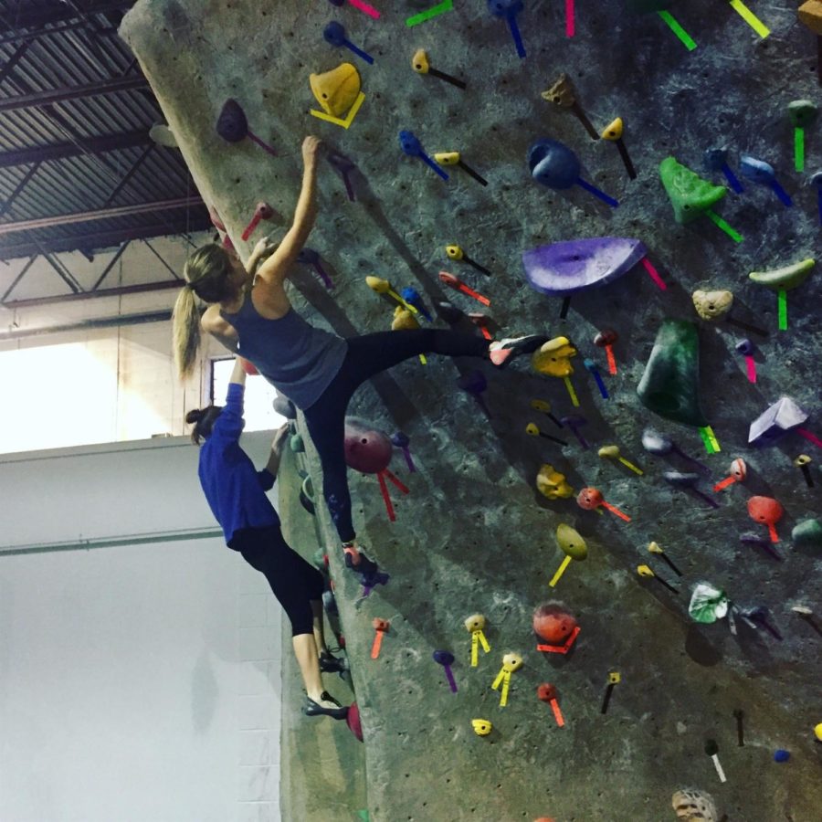 Junior+Lily+Lindquist+carefully+climbs+a+difficult+wall.