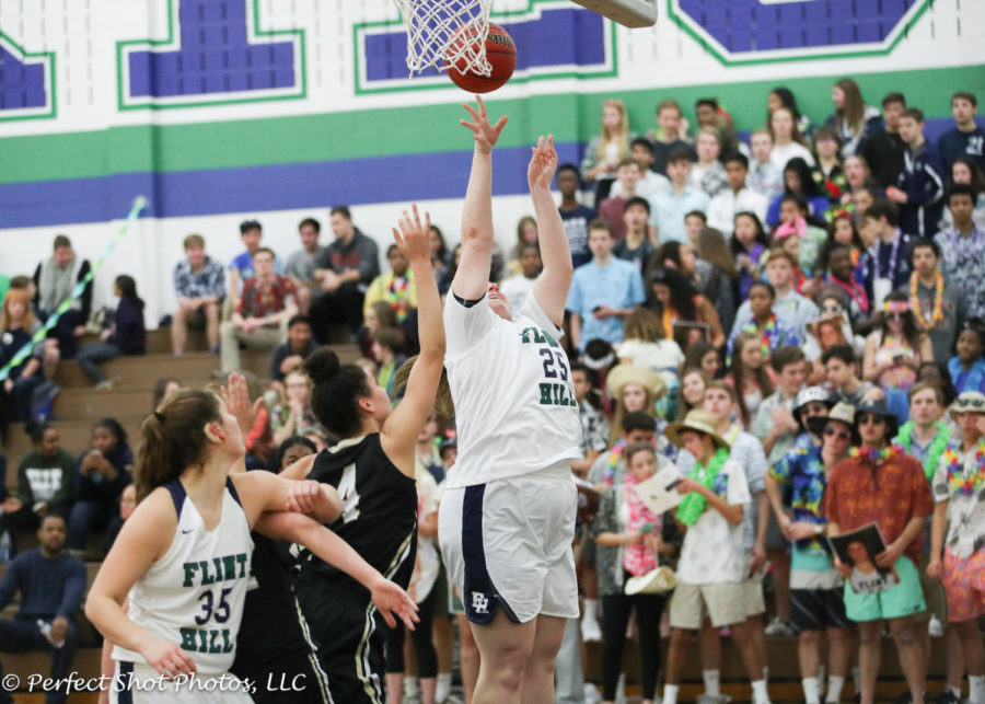 Varsity Girls Basketball player Madison Jordan goes for a rebound against Westfield. 