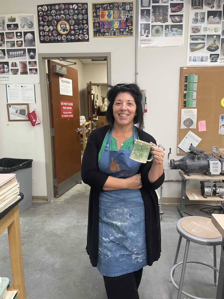 Ms. Cardone holding a mug she created